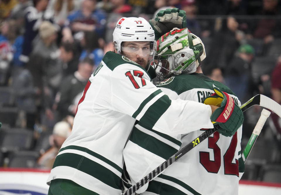 Minnesota Wild left wing Marcus Foligno, left, hugs goaltender Filip Gustavsson after the third period of an NHL hockey game against the Colorado Avalanche Wednesday, March 29, 2023, in Denver. (AP Photo/David Zalubowski)