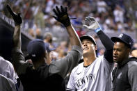 New York Yankees' Anthony Rizzo celebrates in the dugout after hitting a solo home tun during the sixth inning of the team's baseball game against the Miami Marlins, Friday, July 30, 2021, in Miami. (AP Photo/Lynne Sladky)