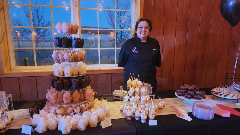 A member of the Cake Company of Canyon awaits attendees with treats Saturday at the 100 Club of the Texas Panhandle's annual Bandfest in Bushland.
