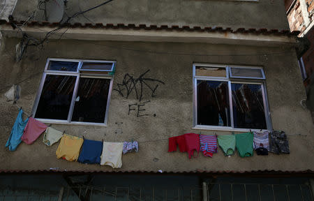 Clothes hang out to dry outside a house marked by bullet holes in Jacarezinho slum in Rio de Janeiro, Brazil, January 10, 2018. REUTERS/Pilar Olivares