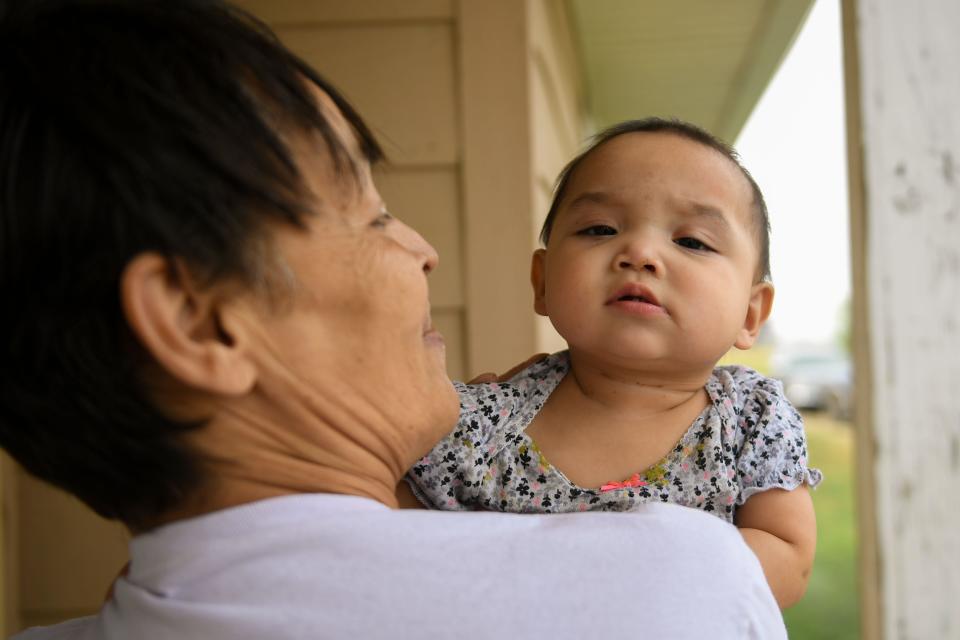 Jewel Bruner holds her 10-month-old granddaughter Emma on the patio of her home in Eagle Butte on Wednesday, Sept. 20, 2023.