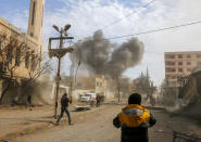 <p>Smoke plumes rise following a reported regime air strike in the rebel-held enclave of Jisreen in the Eastern Ghouta near Damascus, Syria on Feb. 8, 2018. (Photo: Abdulmonam Eassa/AFP/Getty Images) </p>