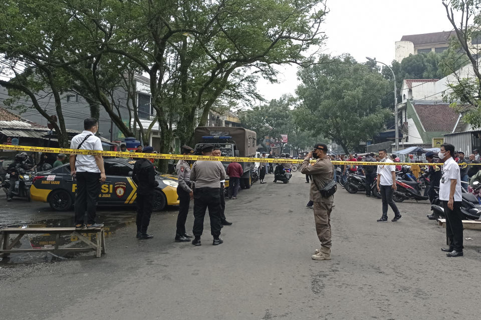 Officers man a road block guard on a street leading to the police station where an explosion went off in Bandung, West Java, Indonesia, Wednesday, Dec. 7, 2022. An unidentified attacker blew himself up outside a police station in Indonesia’s main island of Java on Wednesday in a latest of suicide attacks in the world’s most populous Muslim nation, police said. (AP Photo/Ahmad Fauzan)