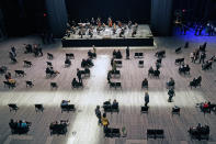 Concertgoers take their seats before a live performance of the New York Philharmonic, which performed for the first time since March 10, 2020, at The Shed in Hudson Yards, Wednesday, April 14, 2021, in New York. (AP Photo/Kathy Willens)