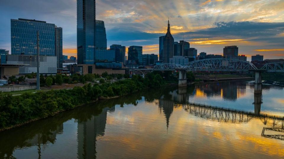 sunset to night view of nashville skyline as seen over the cumberland river