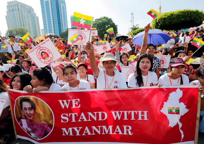People gather to rally in support of Myanmar State Counsellor Aung San Suu Kyi before she heads off to the International Court of Justice (ICJ), in Yangon