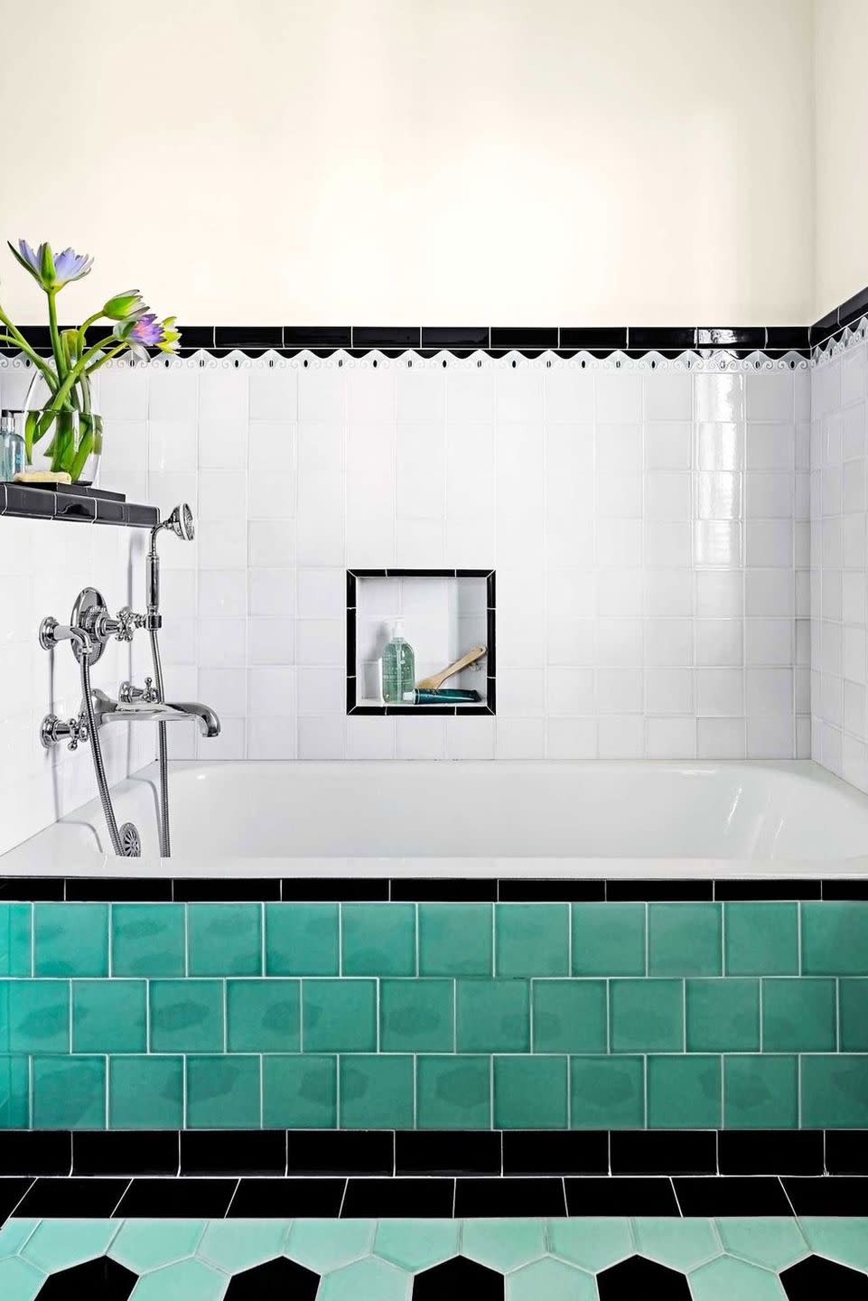 bathroom with vintage bluish green tile and black border accent