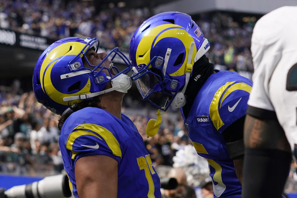 Los Angeles Rams wide receiver Puka Nacua, left, celebrates with wide receiver Tutu Atwell after making a touchdown catch during the first half of an NFL football game against the Philadelphia Eagles Sunday, Oct. 8, 2023, in Inglewood, Calif. (AP Photo/Gregory Bull)