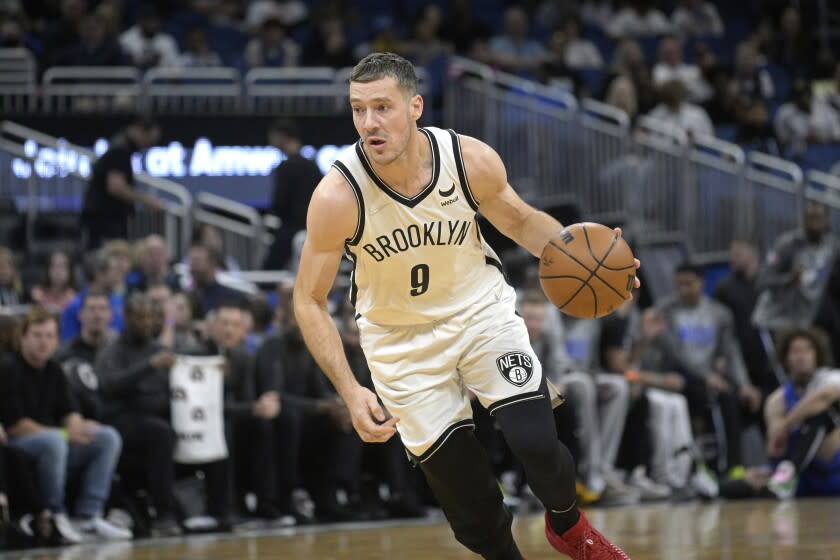 Brooklyn Nets guard Goran Dragic (9) drives to the basket during the first half of an NBA basketball game against the Orlando Magic, Tuesday, March 15, 2022, in Orlando, Fla. (AP Photo/Phelan M. Ebenhack)