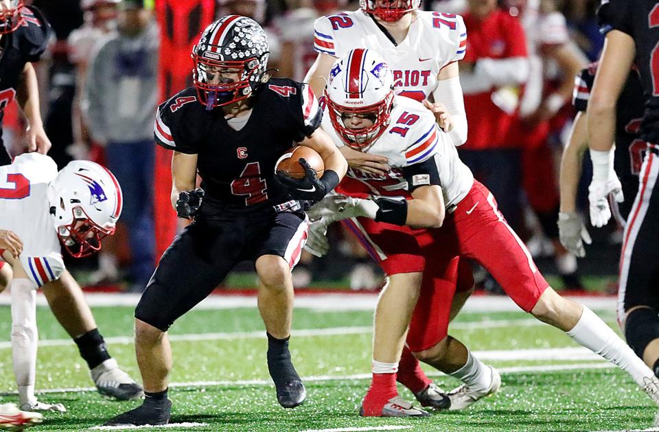 Crestview High School's Adison Reymer (4) runs through a tackle by Patrick Henry High School's Kaden Rosebrook (15) during the OHSAA Division VI second-round high school football playoff game at Scott Bailey Memorial Field Friday, Nov. 4, 2022. TOM E. PUSKAR/ASHLAND TIMES-GAZETTE