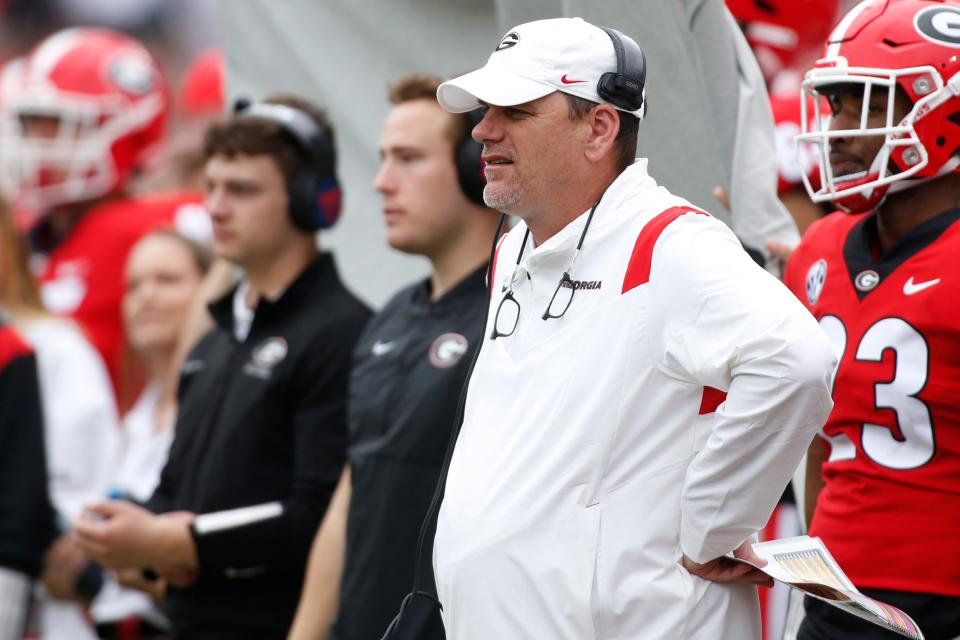 Georgia football analyst Mike Bobo watches from the sideline during the G-Day spring football game in Athens, Ga., on Saturday, April 16, 2022. T