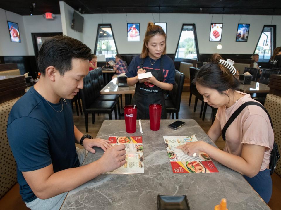 Jie Lin, left, and An Tran place an order with Lin Yan, center, at the newly opened Xian Noodle Place at 6014 North 9th Avenue in Pensacola on Tuesday, August 1, 2023.