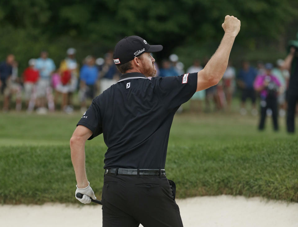 Jimmy Walker reacts after holing out from a green-side bunker on No. 10. (AP)