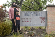 Kristina Negron poses for a photograph with her son, Mason Negron, 6, at his Pleasant Valley Elementary school Tuesday, Sept. 29, 2020, in Schenectady, N.Y. Negron was laid off from her job as an aide for a special education class at Schenectady High School, due to budget cuts. (AP Photo/Hans Pennink)