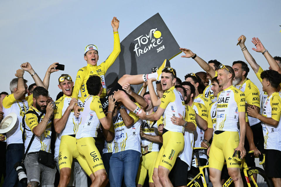 Pogačar celebrates with his UAE Team Emirates teammates. (Marco Bertorello/AFP via Getty Images)