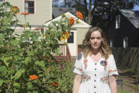 Actor Bethany Anne Lind stands in her backyard garden in Atlanta, wearing a pin in support of the SAG-AFTRA union on Oct. 18, 2023. Lind has been a vocal proponent of the strike, which has had an especially large effect on Atlanta, one of the nation's filming hubs. (AP Photo/R.J. Rico)