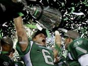 Saskatchewan Roughriders Rob Bagg holds the Grey Cup after his team defeated the Hamilton Tiger Cats to win the CFL's 101st Grey Cup championship football game in Regina, Saskatchewan November 24, 2013. REUTERS/Todd Korol (CANADA - Tags: SPORT FOOTBALL TPX IMAGES OF THE DAY)