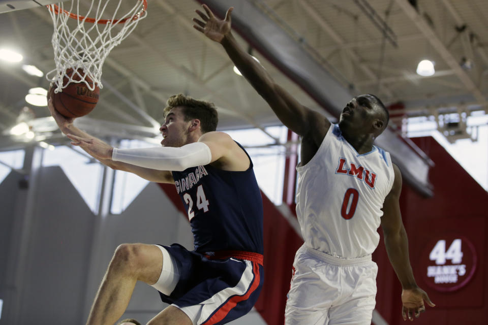 Gonzaga forward Corey Kispert, left, drives past Loyola Marymount guard Eli Scott, right, during the first half of an NCAA college basketball game in Los Angeles, Saturday, Jan. 11, 2020. (AP Photo/Alex Gallardo)