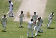 Australia's Mitchell Johnson (3rd R) celebrates with teammates after taking the wicket of England's Matt Prior (top L) during the third day's play in the second Ashes cricket test at the Adelaide Oval December 7, 2013.