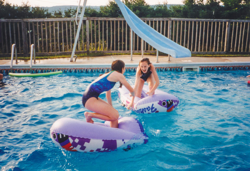 two young girls playing in a swimming pool