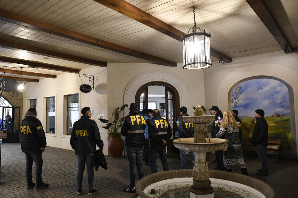 Police officers stand in the Plaza Central Hotel during a judicial raid where the crew of a Venezuelan-owned Boeing 747 cargo plane are staying, in Buenos Aires, Argentina, Tuesday, June 14, 2022. Argentine officials are trying to determine what to do with the cargo plane loaded with automotive parts and an unusually large crew of 17, including at least five Iranians. The plane operated by Venezuela’s state-owned Emtrasur cargo line has been stuck since June 6 at Buenos Aires’ main international airport, unable to depart because of U.S. sanctions against Iran. and suspicions about its crew. (AP Photo/Gustavo Garello)