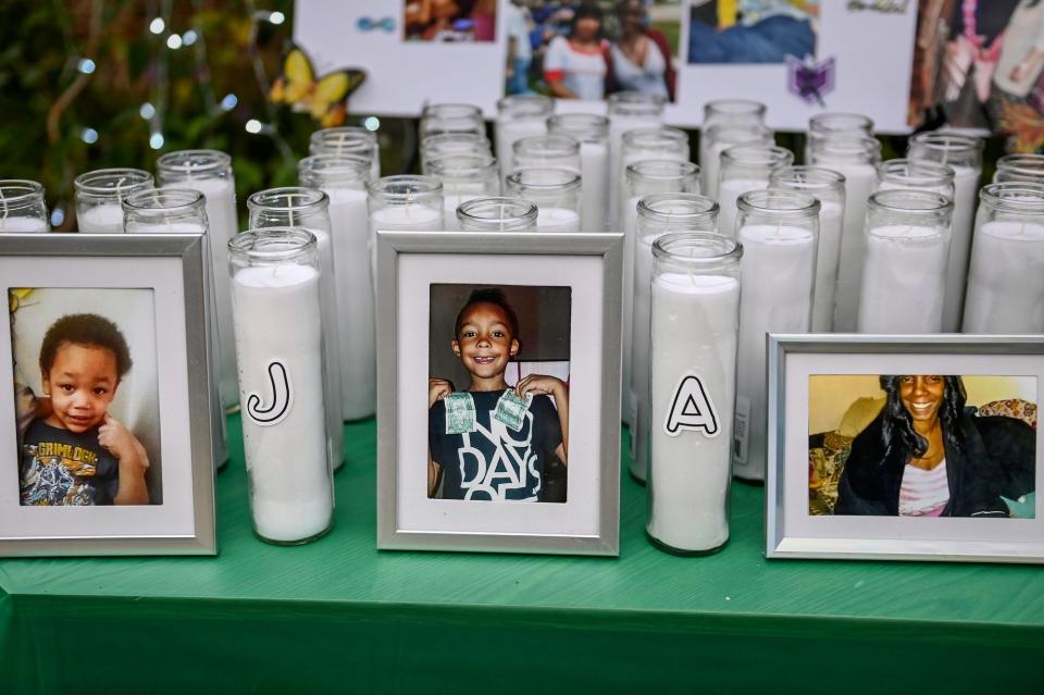 From left, pictures of 4-year-old Jesse Kline IV, 8-year-old Aston Griffin, and their grandmother, Melissa Westen, are displayed during a memorial on Friday, Sept. 3, 2021, in Lansing. The three were killed in a house fire last September.