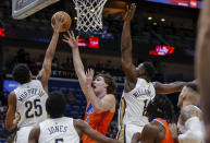 New Orleans Pelicans guard Trey Murphy III (25) blocks a shot by Oklahoma City Thunder guard Josh Giddey in the first quarter of an NBA basketball game in New Orleans, Monday, Nov. 28, 2022. (AP Photo/Derick Hingle)