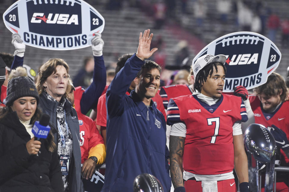 CORRECTS LAST NAME OF COACH TO CHADWELL, INSTEAD OF FALWELL - Liberty coach Jamey Chadwell waves after the team's win over New Mexico State during the Conference USA championship NCAA college football game Friday, Dec. 1, 2023, in Lynchburg, Va. (Paige Dingler/The News & Advance via AP)