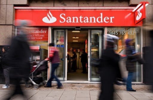 Shoppers pass a Santander branch in central London, 2010. Spain has tipped back into recession, official data showed, grim news for a cash-strapped economy hobbled by rising debt, soaring unemployment and deeply troubled banks