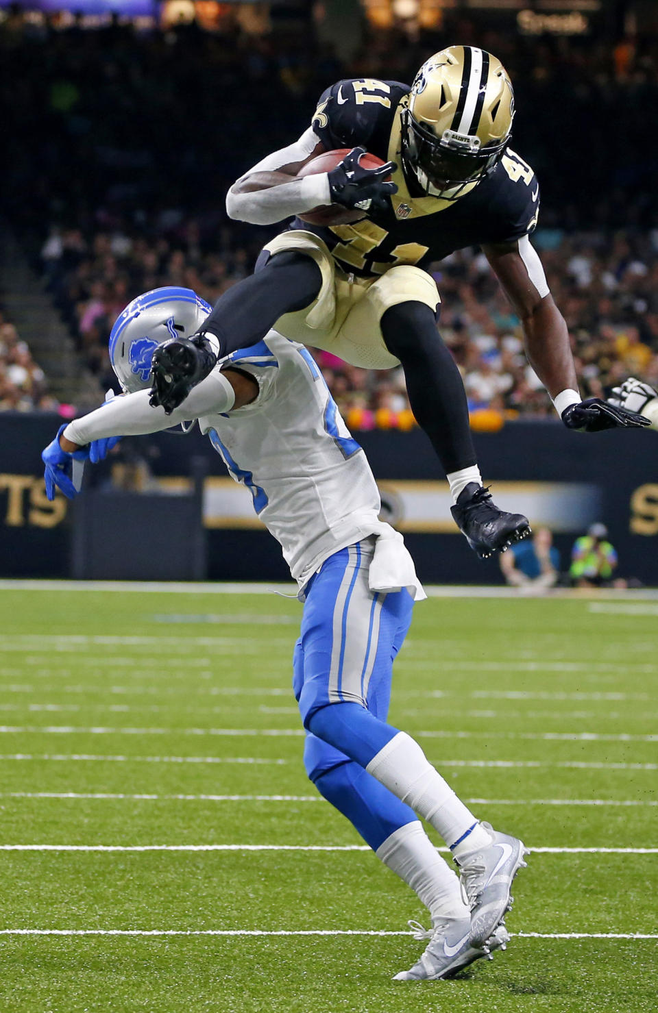 <p>New Orleans Saints running back Alvin Kamara (41) leaps over Detroit Lions cornerback Darius Slay in the second half of an NFL football game in New Orleans, Sunday, Oct. 15, 2017. (AP Photo/Butch Dill) </p>