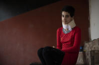 Hoda Kinno, 11, poses for a photograph at a temporary apartment in the coastal town of Jiyeh, south of Beirut, Lebanon, Tuesday, Sept. 22, 2020. The Kinno family from Syria's Aleppo region was devastated in the wake of the Aug. 4 explosion at the Beirut port -- Hoda suffered a broken neck and other injuries and her sister Sedra, 15, died in the explosion. (AP Photo/Hassan Ammar)