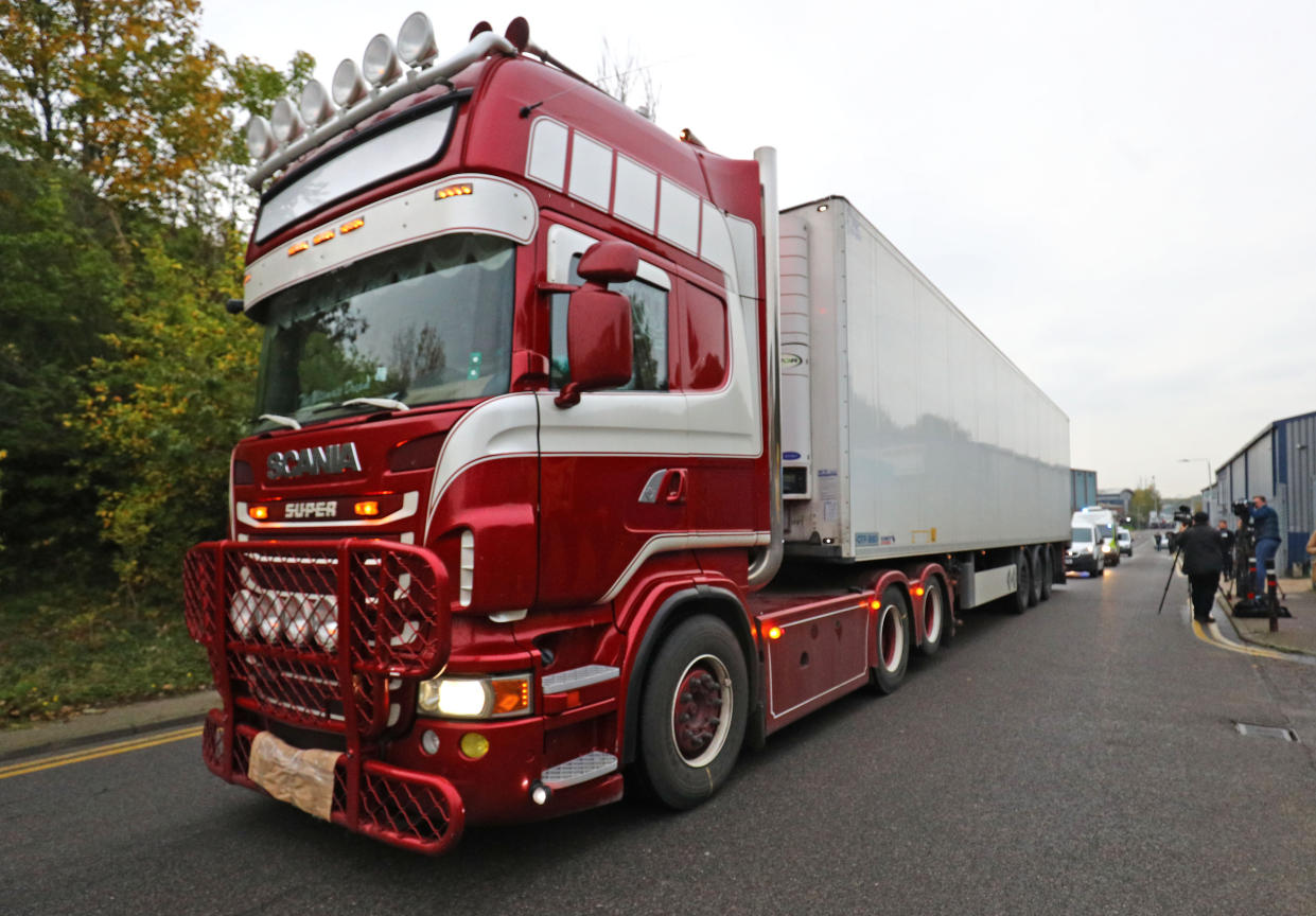 The container lorry where 39 people were found dead inside leaves Waterglade Industrial Park in Grays, Essex, heading towards Tilbury Docks under police escort.