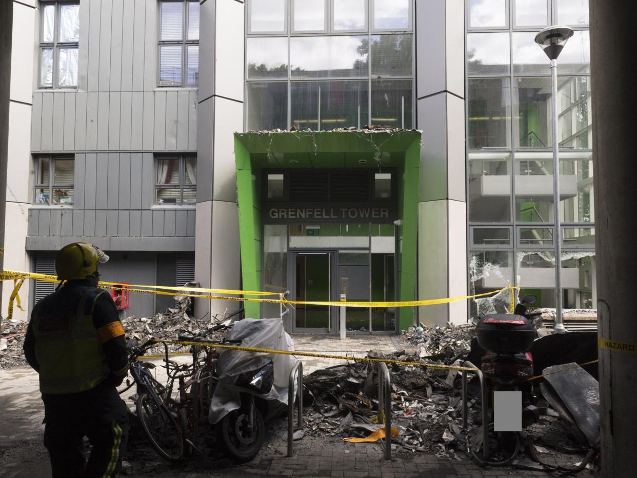 Emergency crews outside the front entrance to the tower: Metropolitan Police