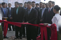Cambodian Prime Minister Hun Manet, center, cuts the ribbon to inaugurate the Siem Reap-Angkor International Airport, in Cambodia, Thursday, Nov. 16, 2023. Cambodia on Thursday officially inaugurated the country's newest and biggest airport, a Chinese-financed project meant to serve as an upgraded gateway to the country’s major tourist attraction, the centuries-old Angkor Wat temple complex in the northwestern province of Siem Reap. (AP Photo/Heng Sinith)