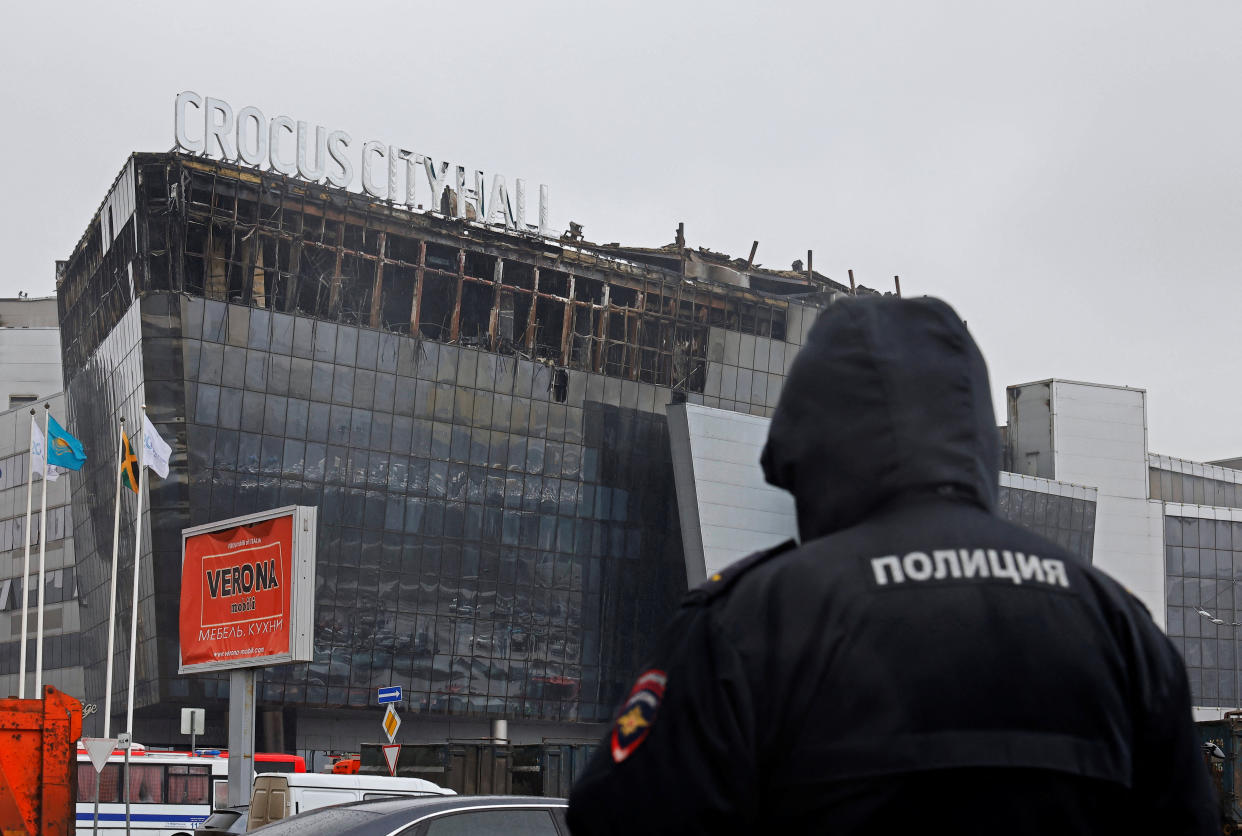 A police officer stands in front of the Crocus City Hall concert venue following Friday's shooting attack and fire, in the Moscow Region, Russia March 24, 2024. REUTERS/Maxim Shemetov