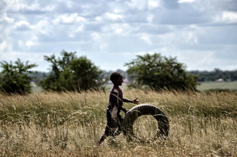 "Thatched villages appeared intermittently and we'd see children running with tyres" - Credit: Getty