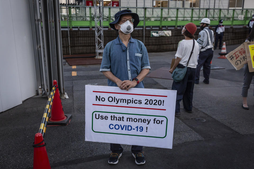 TOKYO, JAPAN - JULY 16: A man holds a placard during a demonstration against the forthcoming Tokyo Olympic Games on July 16, 2021 in Tokyo, Japan. Protesters gathered to demonstrate against International Olympic Committee President Thomas Bach’s visit to Hiroshima amid concern over the safety of holding the Games during the global coronavirus pandemic. (Photo by Yuichi Yamazaki/Getty Images)