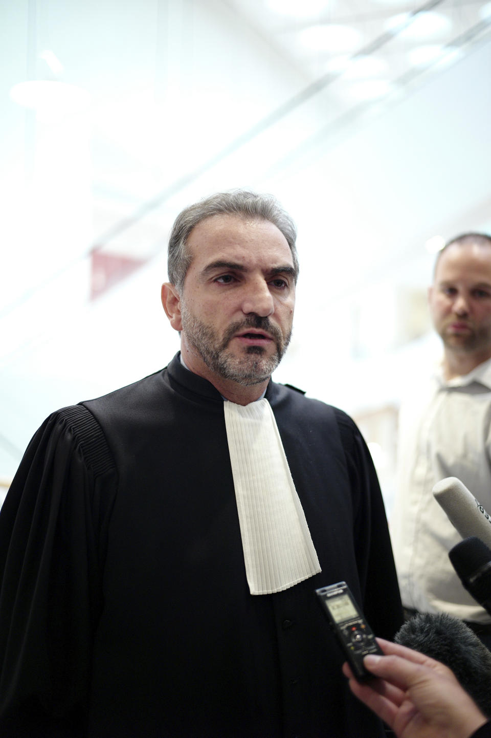 The plumber's lawyer Georges Karouni, speaks to the press at the courthouse, in Paris, Thursday, Sept. 12, 2019. The only daughter of Saudi Arabia's King Salman has been found guilty by a Paris court of charges that she ordered her bodyguard to detain and strike a plumber for taking photos at the Saudi royal family's apartment in the French capital. (AP Photo/Thibault Camus)