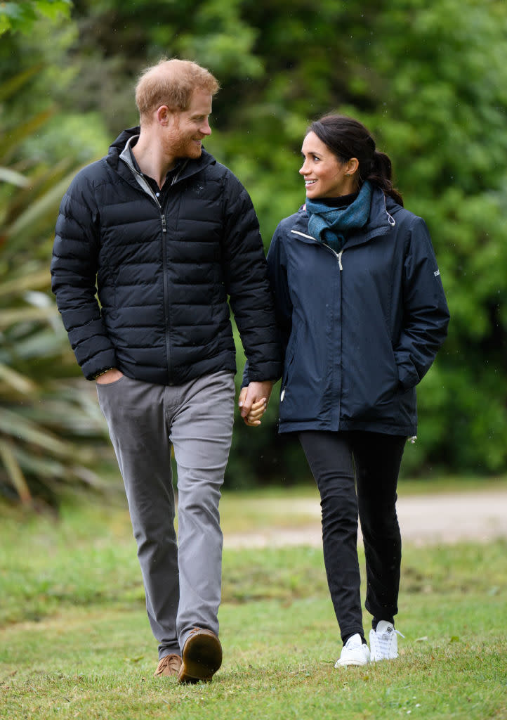 Prince Harry and Meghan Markle, who is wearing Stella McCartney’s vegan take on Stan Smith sneakers, visit Abel Tasman National Park in New Zealand. (Photo: Getty Images)