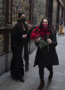 Spanish Flamenco dancer Anabel Moreno, left, is given a rose outside the Villa Rosa Tablao flamenco venue during a protest in Madrid, Spain, Thursday March 4, 2021. The National Association of Tablaos protested outside the mythical Villa Rosa Tablao which has been forced to close permanently due to the covid pandemic. (AP Photo/Paul White)