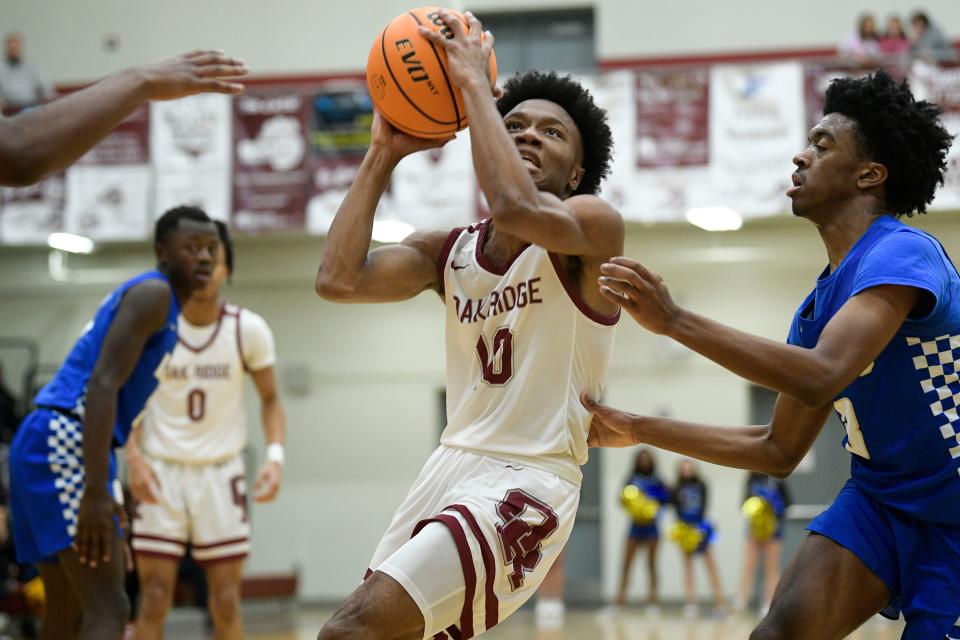 Oak Ridge's Brennen Scott (10) goes for a shot as Karns' Bubba Faulkner (3) defends during a basketball game in Oak Ridge, Tenn., on Tuesday, Jan. 31, 2023.