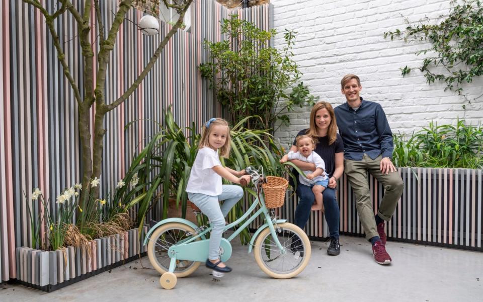 Couple Laura Sanjuan and Russell Porter with their daughter Isabella, four, and Oscar, one, at home in Clapham. - Andrew Crowley