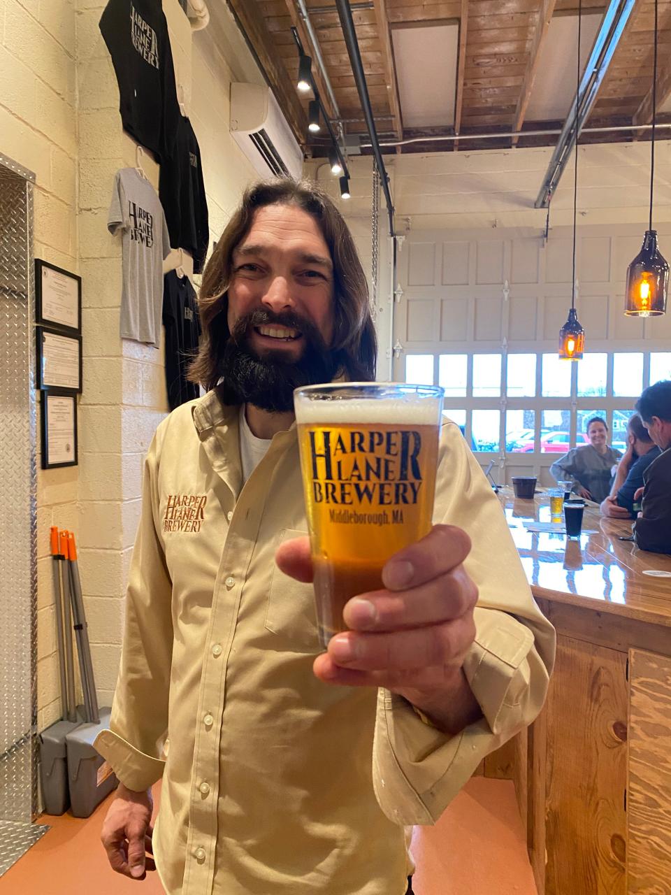 Mike Pasalacqua, owner of Harper Lane Brewery in Middleboro, on Friday, Jan. 26, 2024 toasts the opening of the taproom the day before.