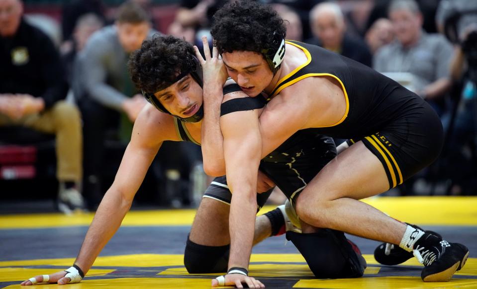 Dublin Coffman's Omar Ayoub, left, competes against Lakewood St. Edward's Ryan Bennett in the 144-pound state final in Division I.