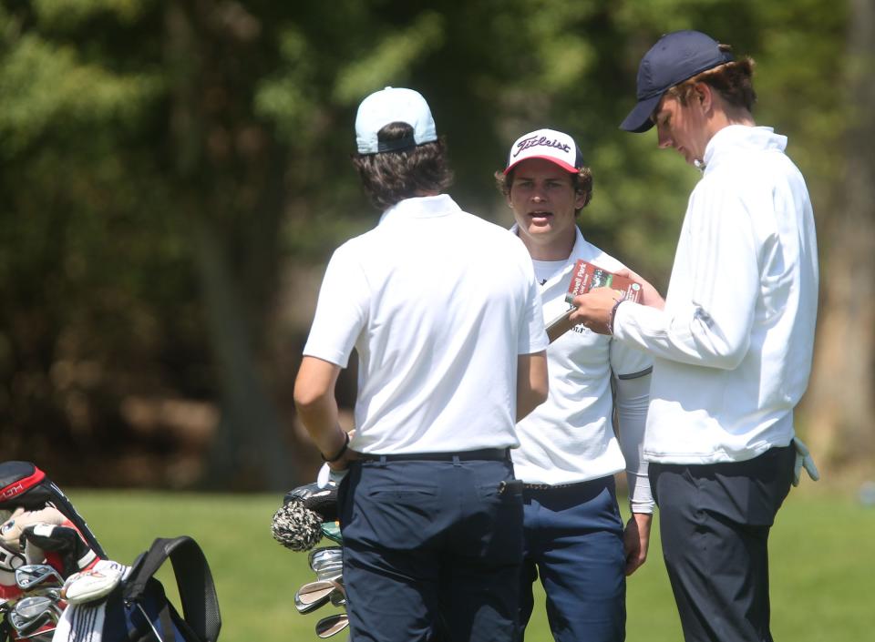 Wall's Pat Scenna (center) talks with fellow players Matt Colannino of CBA (left) and  Richie Rech of Middletown South on the 12th hole during the Monmouth County Tournament boys golf at Howell Park Wednesday, April 19, 2023.
