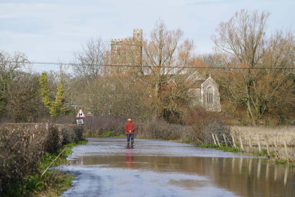 A man looks at floodwater in Harbridge, Hampshire. (Andrew Matthews/PA Wire)