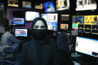 Sonia Niazi a TV anchor works in a TOLO NEWS studio while covering her face, in Kabul, Afghanistan, Sunday, May 22, 2022. Afghanistan's Taliban rulers have begun enforcing an order requiring all female TV news anchors in the country to cover their faces while on-air. The move Sunday is part of a hard-line shift drawing condemnation from rights activists. (AP Photo/Ebrahim Noroozi)