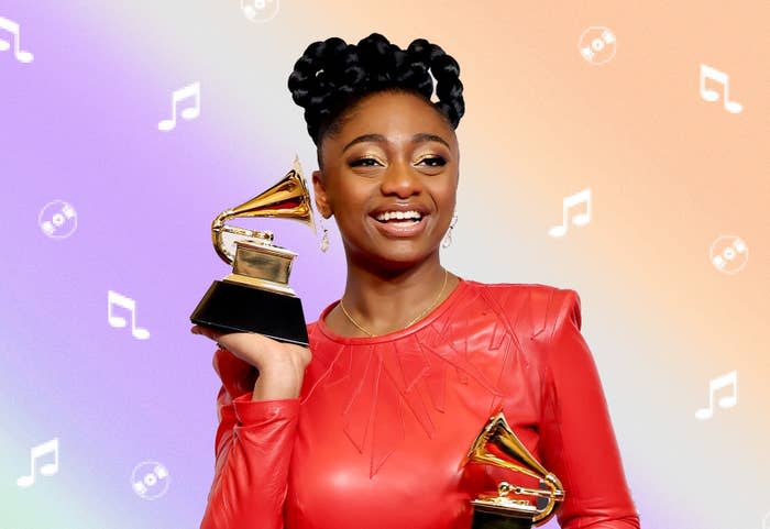 Singer Samara Joy smiling and holding Grammy awards