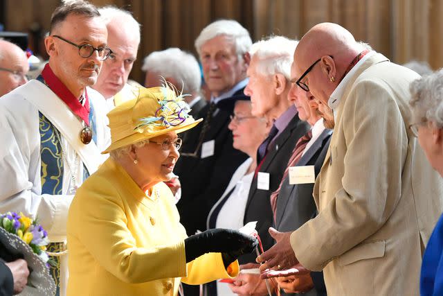 ARTHUR EDWARDS/AFP via Getty Images Queen Elizabeth distributes Maundy money during the Royal Maundy Service at St George's Chapel in 2019.