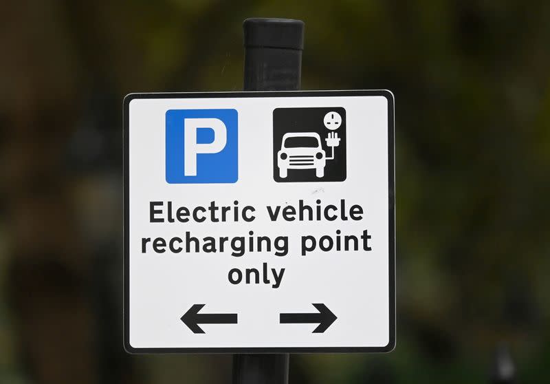 FILE PHOTO: FILE PHOTO: A roadside EV (electric vehicle) charge point sign is seen in London